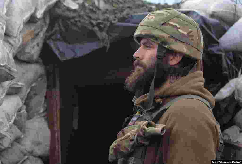 A Ukrainian soldier stands guard near Donetsk.&nbsp;Kremlin spokesman Dmitry Peskov says there is nothing to fear and that the repositioning of military forces within Russia&#39;s borders is a strictly domestic concern.