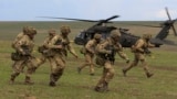 British soldiers disembark from a US military helicopter during the Wind Spring 15 NATO military exercises in Romania on April 21.