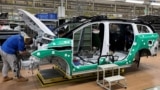 Employees work on an electric vehicle (EV) production line at a factory of Jiangling Group Electric Vehicle in Nanchang, Jiangxi Province, China.