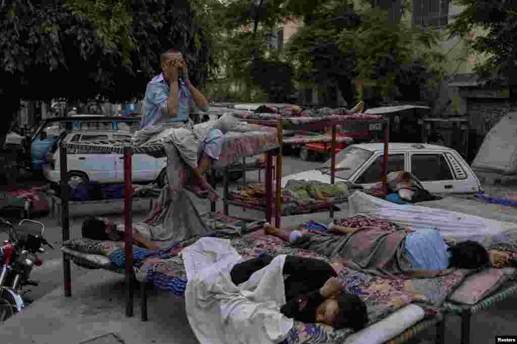 A man awakens during a heatwave that forced residents to seek shelter outdoors in Rawalpindi, Pakistan.