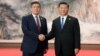 Then-Kyrgyz President Sooronbai Jeenbekov (left) and Chinese President Xi Jinping met on the sidelines of the Shanghai Cooperation Organization summit in Qingdao in June 2018.