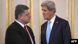 Ukrainian President Petro Poreshenko (left) greets U.S. Secretary of State John Kerry prior to their meeting in Kyiv on February 5.