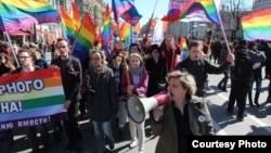 Natalya Tsymbalova (right foreground) leads a march by the Alliance of Heterosexuals for LGBT Equality in St. Petersburg.