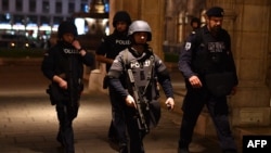 Armed policemen patrol in the center of Vienna, Austria, following a shooting incident in November 2020.