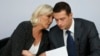 French far-right politician Marine Le Pen speaks to Jordan Bardella, the leader of her National Rally party, in Paris in September 2024.