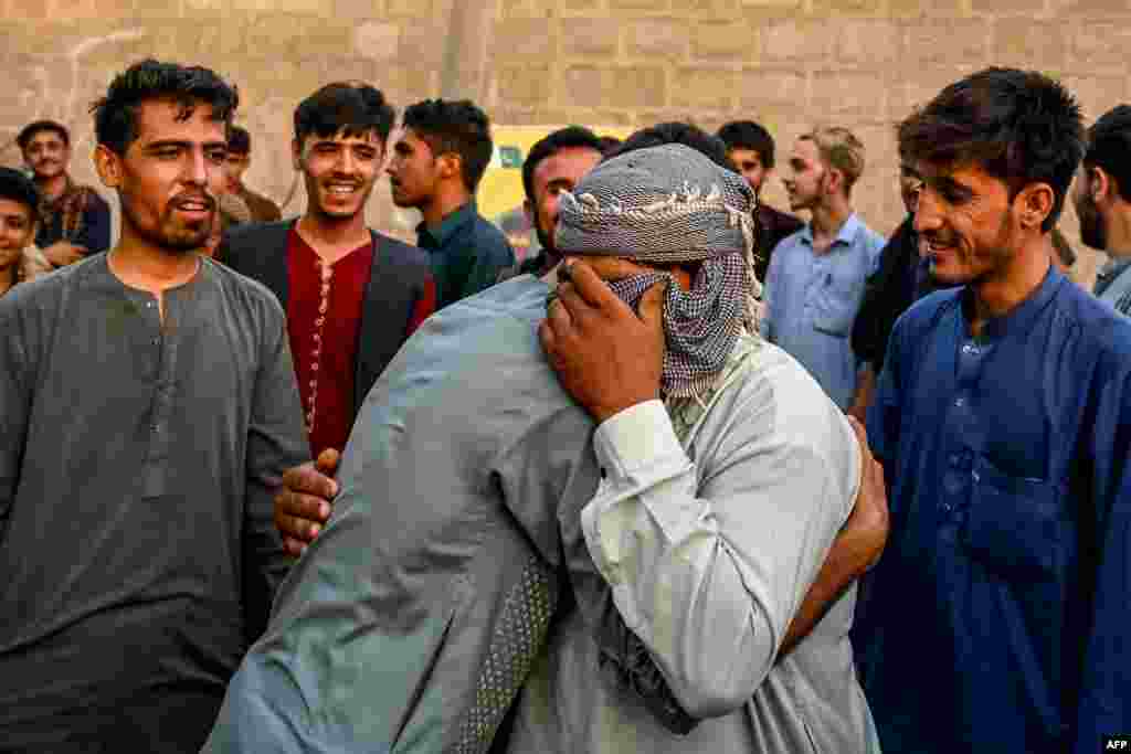 Afghan refugees embrace each other before leaving for Afghanistan at a bus stand in Karachi. Thousands of Afghan refugees living in Pakistan have been forcibly repatriated since Pakistani authorities set an April 10 deadline for those without documents to leave the country.