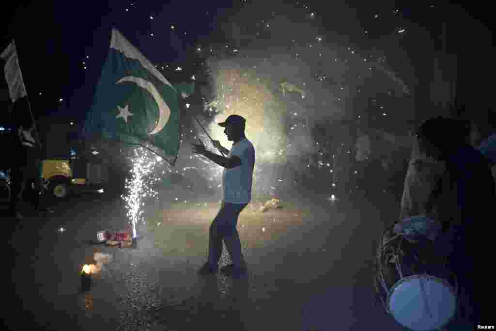 Residents of Hyderabad, Pakistan, celebrate after the announcement of a cease-fire between Islamabad and New Delhi after weeks of exchanges over the disputed Kashmir region.
