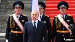 Russian President Putin addresses service members in Moscow on June 27.