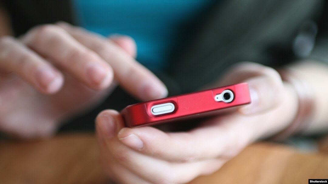Czech republic. Hands holding smartphone. social media. Shutterstock.