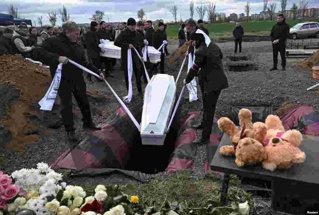 Mourners attend a funeral ceremony on April 7 for two children who were killed in a Russian missile strike on the Ukrainian town of Kryviy Rih three days earlier.