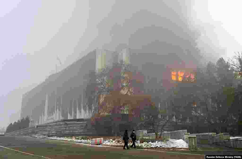 The mayor's office in central Almaty burns on January 6 after being stormed and ransacked by protesters a day earlier.