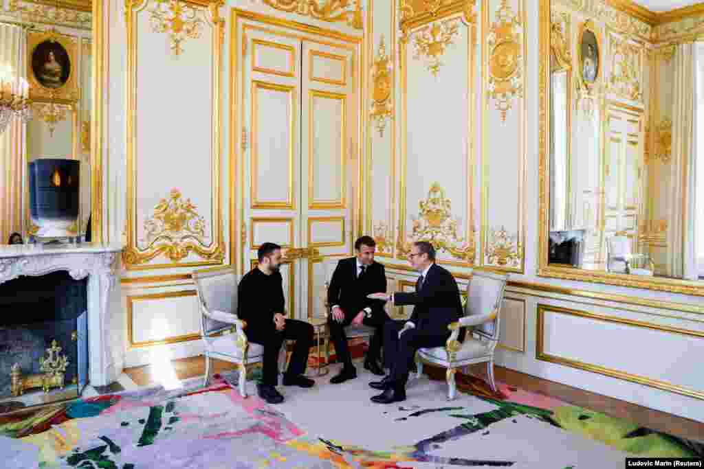 Ukrainian President Volodymyr Zelenskiy (left), French President Emmanuel Macron (center), and UK Prime Minister Keir Starmer speak together at a meeting in the Elysee Palace in Paris.