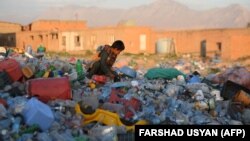 An Afghan child works in a plastic recycling factory on the outskirts of Mazar-i-Sharif.