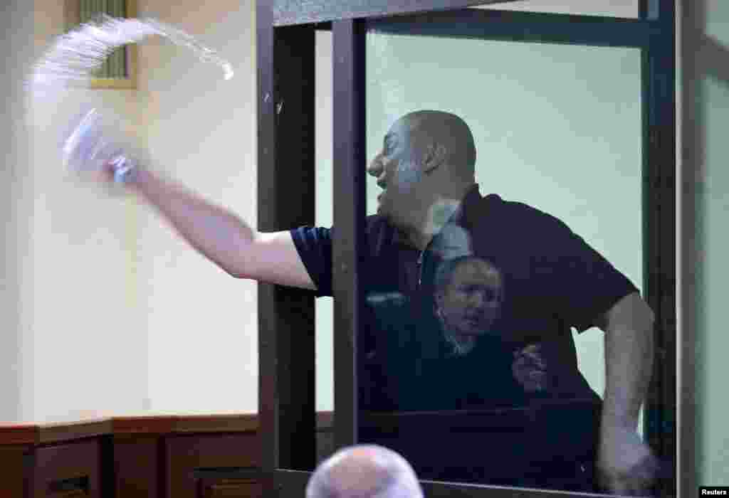 Detained Georgian opposition leader Nika Melia splashes water toward a judge during a court hearing in Tbilisi.