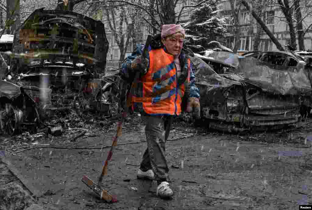 A Ukrainian municipal worker cleans an area at the site of a Russian drone strike on Dnipro on April 9.