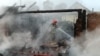 A rescuer extinguishes a fire following a drone strike in Pryluky, Chernihiv region, Ukraine, on June 5. 