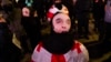 Protesters in Tbilisi wear masks in defiance of a new law banning face-coverings in Georgia.