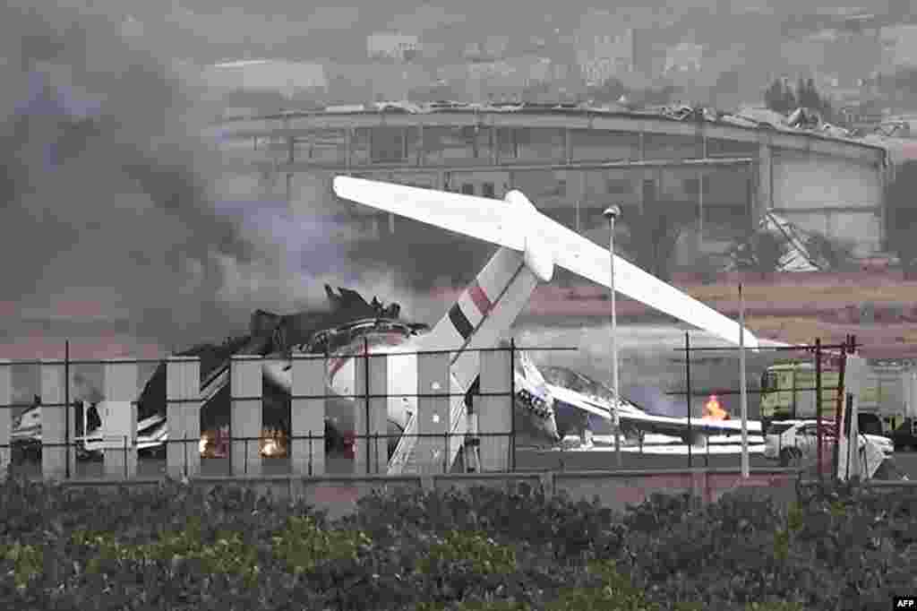 A handout picture released by the Houthi-affiliated branch of the Yemeni News Agency SABA on May 6 shows a firefighter truck extinguishing a blaze on a burning airplane at Sanaa international airport after Israeli military warplanes struck Yemen's rebel-held capital in retaliation for a missile attack by the Iran-backed Houthis on Israel's main airport.