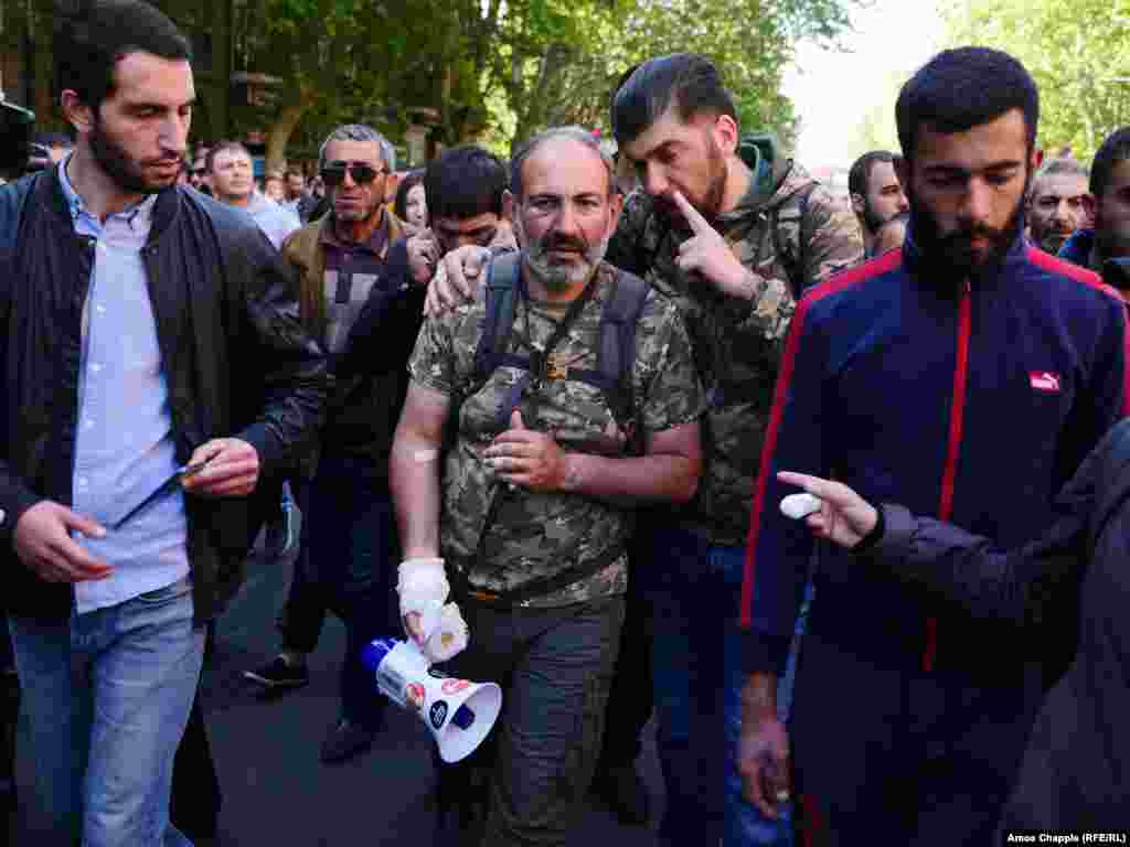  نیکول پاشینیان رهبر مخالفان (وسط تصویر)؛ او خود در جریان درگیری‌های خیابانی زخمی شده‌است.