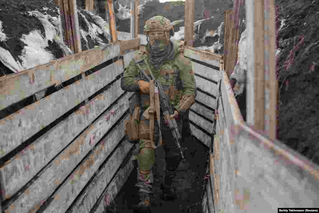 A soldier patrols trenches manned by Ukrainian government forces near Donetsk. Dozens of Ukrainian military personnel have been killed since the start of 2020.